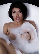 Zena Lynn in a bubbly tub jacking off her dick until she cums hard